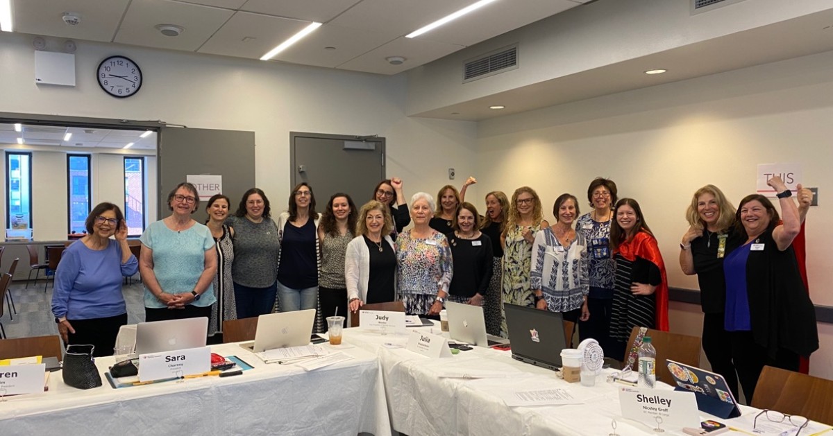 WRJ Executive Committee Members standing around white tables