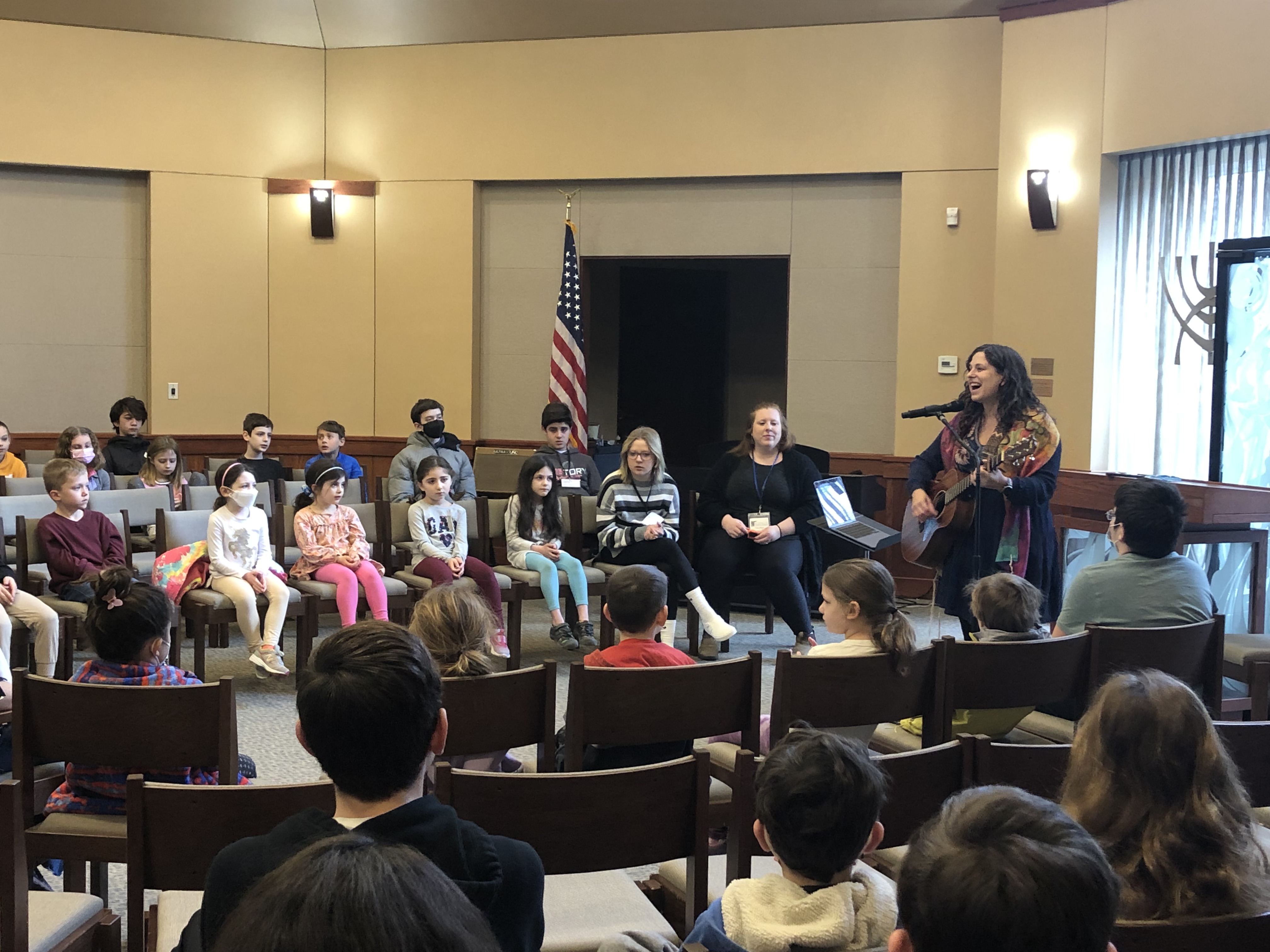 Kids concert with audience and someone playing guitar