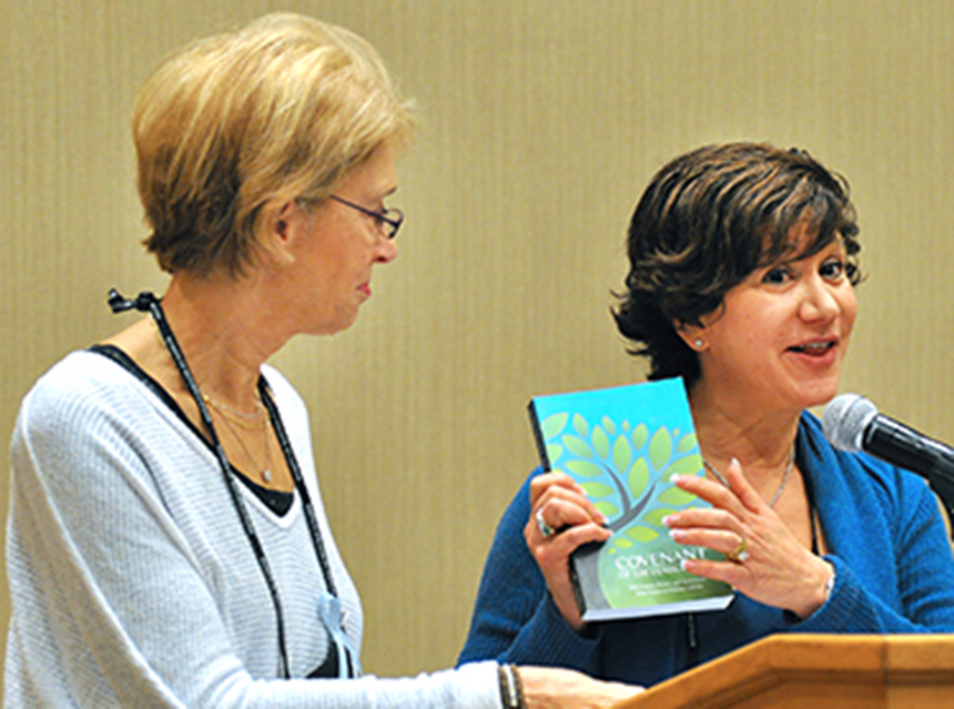 Women holding up book