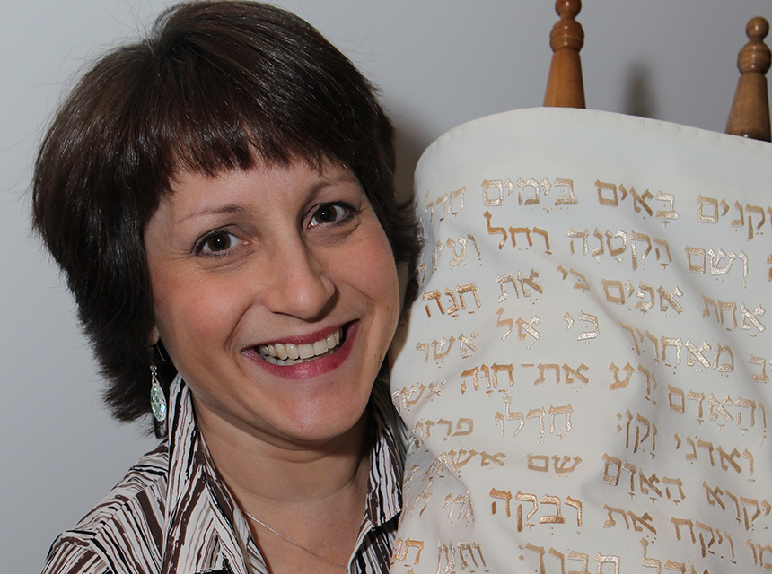 Woman holding up the torah